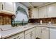 Bright kitchen featuring cream-colored cabinets and countertops, paired with decorative backsplash at 6409 41St N Ave, St Petersburg, FL 33709