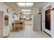 Bright kitchen with white cabinetry, dining area, and tiled floors at 6409 41St N Ave, St Petersburg, FL 33709