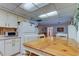 Eat in kitchen featuring light cabinets and countertops with seating adjacent to the dining area at 6409 41St N Ave, St Petersburg, FL 33709