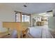 Spacious living room with a piano, and sliding glass doors to a porch and view of kitchen and eating area at 6409 41St N Ave, St Petersburg, FL 33709