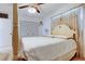 Serene main bedroom featuring a four-poster bed, ceiling fan, and natural light from the windows at 6409 41St N Ave, St Petersburg, FL 33709