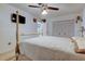 Inviting main bedroom showcasing a four-poster bed, ceiling fan, and TV at 6409 41St N Ave, St Petersburg, FL 33709