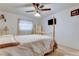 Main bedroom showing bed with a four-poster frame, ceiling fan, and natural light at 6409 41St N Ave, St Petersburg, FL 33709