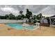 Backyard swimming pool with lion decor and lush tropical landscaping at 6409 41St N Ave, St Petersburg, FL 33709