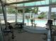 Sunroom featuring fitness equipment with an overview of a gorgeous pool area in backyard at 6409 41St N Ave, St Petersburg, FL 33709