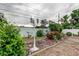 Landscaped yard with a vintage lamp post, lush greenery, and flowering shrubs at 6409 41St N Ave, St Petersburg, FL 33709