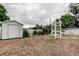 Well-maintained yard with a shed, pergola, and mature trees, offering privacy at 6409 41St N Ave, St Petersburg, FL 33709