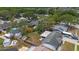 Aerial view of a landscaped backyard with a patio set and the home's exterior at 6639 Winding Oak Dr, Tampa, FL 33625