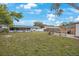 Large, well-maintained backyard featuring lush grass, a patio set, and a glimpse of the home's rear exterior at 6639 Winding Oak Dr, Tampa, FL 33625