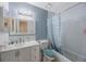 This updated bathroom features a vanity with sink, mirror and shower/tub combo at 6639 Winding Oak Dr, Tampa, FL 33625