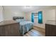 This bedroom features a bed, wooden floors, and a window at 6639 Winding Oak Dr, Tampa, FL 33625