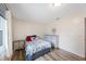 This well-lit bedroom has light hardwood floors and neutral colored dressers at 6639 Winding Oak Dr, Tampa, FL 33625