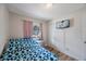 This bedroom features wood floors, a large window with curtains and a mounted television at 6639 Winding Oak Dr, Tampa, FL 33625
