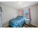 This cozy bedroom includes wood floors, a window with curtains and a three drawer dresser at 6639 Winding Oak Dr, Tampa, FL 33625