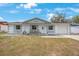 Charming single-story home with a well-maintained lawn and inviting front porch seating at 6639 Winding Oak Dr, Tampa, FL 33625
