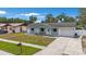 Charming home with well-manicured lawn, cozy front porch seating, and an attached garage with driveway at 6639 Winding Oak Dr, Tampa, FL 33625