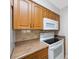 A kitchen features a white stove, wood cabinets, and a white microwave at 6639 Winding Oak Dr, Tampa, FL 33625
