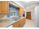 A kitchen features wood cabinets, a stainless steel sink, and tile flooring at 6639 Winding Oak Dr, Tampa, FL 33625