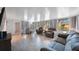 The well-lit living room features large windows, tile floors, and comfortable seating at 6639 Winding Oak Dr, Tampa, FL 33625
