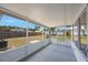 Enclosed outdoor patio with screened windows overlooks the fenced-in backyard at 6639 Winding Oak Dr, Tampa, FL 33625
