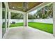 A covered back porch overlooks a lush, green lawn and fenced backyard at 710 W Plymouth St, Tampa, FL 33603