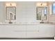Modern bathroom with double vanities with marble countertops, and updated lighting at 710 W Plymouth St, Tampa, FL 33603