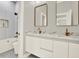 Bathroom featuring double vanities, marble countertops, and bronze fixtures at 710 W Plymouth St, Tampa, FL 33603