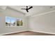 Bright bedroom with hardwood floors, large windows, ceiling fan and neutral paint at 710 W Plymouth St, Tampa, FL 33603