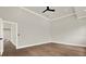 A spacious bedroom with hardwood floors and an open doorway to another room at 710 W Plymouth St, Tampa, FL 33603