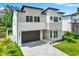 Contemporary home with stone accents, a modern garage door, and manicured landscaping at 710 W Plymouth St, Tampa, FL 33603