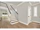 Elegant foyer featuring hardwood floors, a modern staircase, and plenty of natural light at 710 W Plymouth St, Tampa, FL 33603