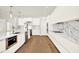 Modern kitchen featuring white cabinetry, marble countertops and backsplash, and stainless steel appliances at 710 W Plymouth St, Tampa, FL 33603