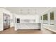 Bright kitchen featuring a large island with waterfall countertops, stainless appliances and hardwood floors at 710 W Plymouth St, Tampa, FL 33603