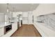 Modern kitchen with an island, stainless steel appliances, and sleek white cabinetry at 710 W Plymouth St, Tampa, FL 33603