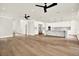 Open-concept living room and kitchen area with hardwood floors and modern ceiling fans at 710 W Plymouth St, Tampa, FL 33603