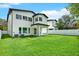 The home's backyard is expansive with manicured lawn and white privacy fence at 712 W Plymouth St, Tampa, FL 33603