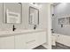 Modern bathroom showcasing double vanity, sleek mirrors and stylish tile in shower at 712 W Plymouth St, Tampa, FL 33603