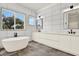 Bright bathroom with freestanding tub, double vanity, and a view to the outdoors at 712 W Plymouth St, Tampa, FL 33603