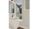 This bright bathroom has a single vanity, light fixtures, and a window to the outside at 712 W Plymouth St, Tampa, FL 33603