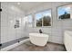 Modern bathroom with freestanding tub, glass shower, and tile surround at 712 W Plymouth St, Tampa, FL 33603