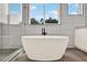 White freestanding bathtub with black faucet and tiled backsplash at 712 W Plymouth St, Tampa, FL 33603
