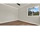 Bedroom with hardwood floors, ceiling fan, and outdoor views at 712 W Plymouth St, Tampa, FL 33603