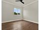 A bright bedroom with hardwood floors, white trim and a ceiling fan at 712 W Plymouth St, Tampa, FL 33603