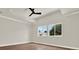 A spacious bedroom with a ceiling fan, hardwood floors, recessed lighting, and large windows at 712 W Plymouth St, Tampa, FL 33603