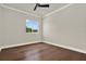 A bright bedroom with hardwood floors, white trim and a ceiling fan at 712 W Plymouth St, Tampa, FL 33603