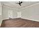 A spacious bedroom with doors to other rooms, hardwood floors, and neutral colored walls at 712 W Plymouth St, Tampa, FL 33603