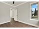 This is a well lit bedroom with hardwood floors and an open door to another room at 712 W Plymouth St, Tampa, FL 33603