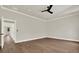 Spacious bedroom with hardwood floors, ceiling fan, and white trim throughout at 712 W Plymouth St, Tampa, FL 33603