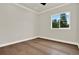 A neutral bedroom featuring hardwood floors and plenty of natural light at 712 W Plymouth St, Tampa, FL 33603