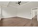 A spacious bedroom features hardwood floors, white trim, and a modern ceiling fan at 712 W Plymouth St, Tampa, FL 33603